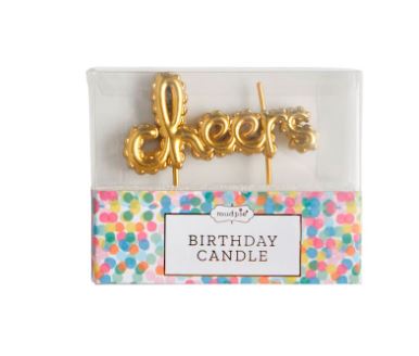 Wax candle by Mud Pie featuring a metallic gold balloon-style Cheers script in a clear display box with a colorful confetti base and the label Birthday Candle
