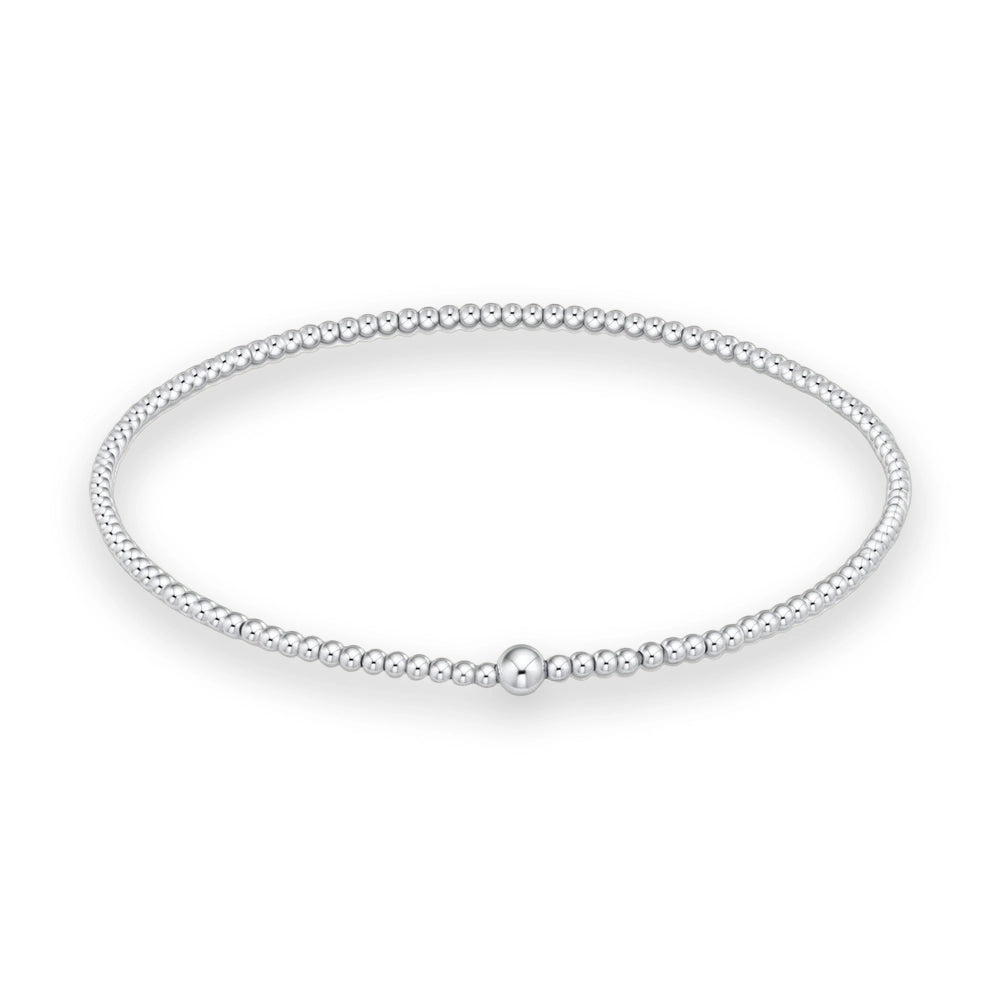 Sterling silver beaded bracelet featuring a large polished central focal bead and a continuous strand of uniform high-shine spherical beads on a white studio background