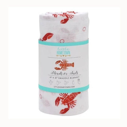 Muslin swaddle blanket by Little Hometown featuring a rolled baby blanket with a vibrant red lobster print and a decorative teal paper band on a white background