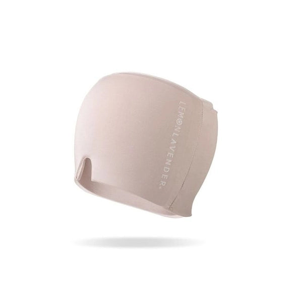 Product photograph by Lemon Lavender of a soft blush pink headache relief cap isolated on a white background featuring a vertical brand logo and a small V-shaped nose cutout notch