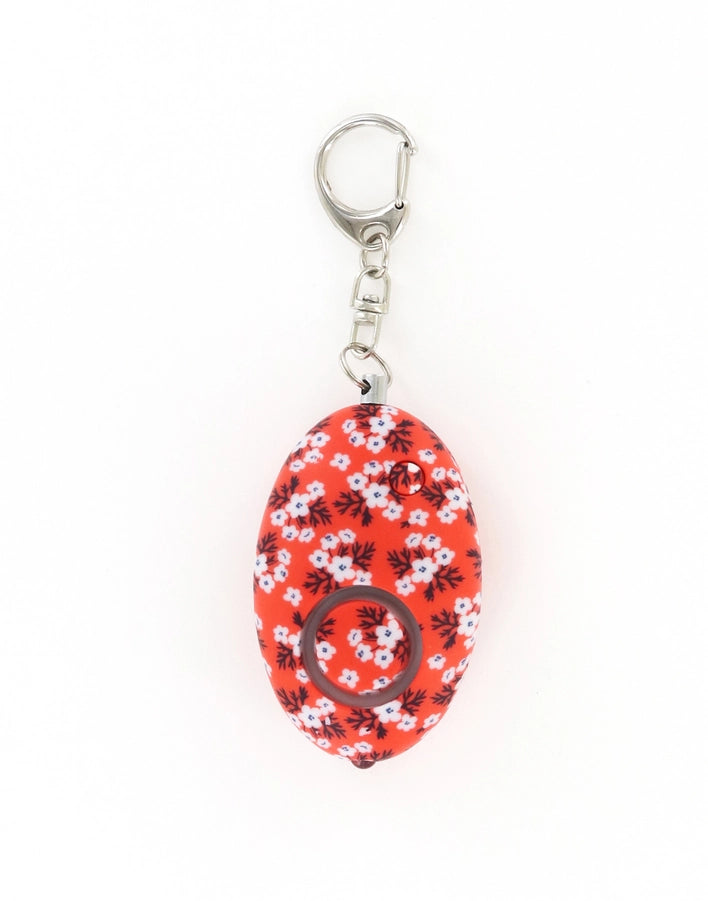 Red egg-shaped alarm keychain with white blossom print