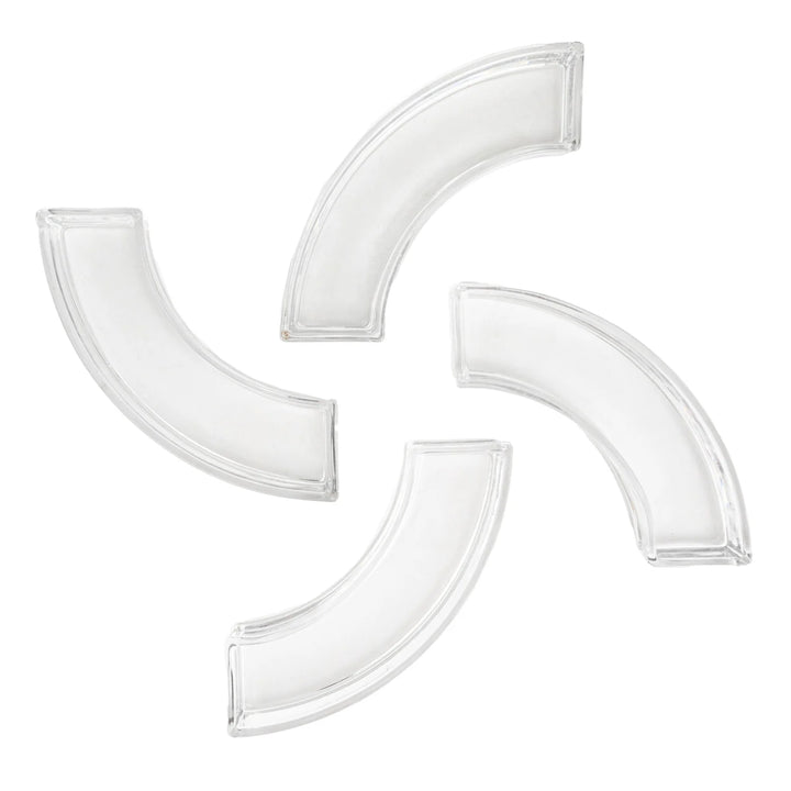 Clear glass modular centerpiece segments featuring four curved hollow pieces arranged in a pinwheel formation against a white background with translucent beveled edges and a minimalist geometric aesthetic