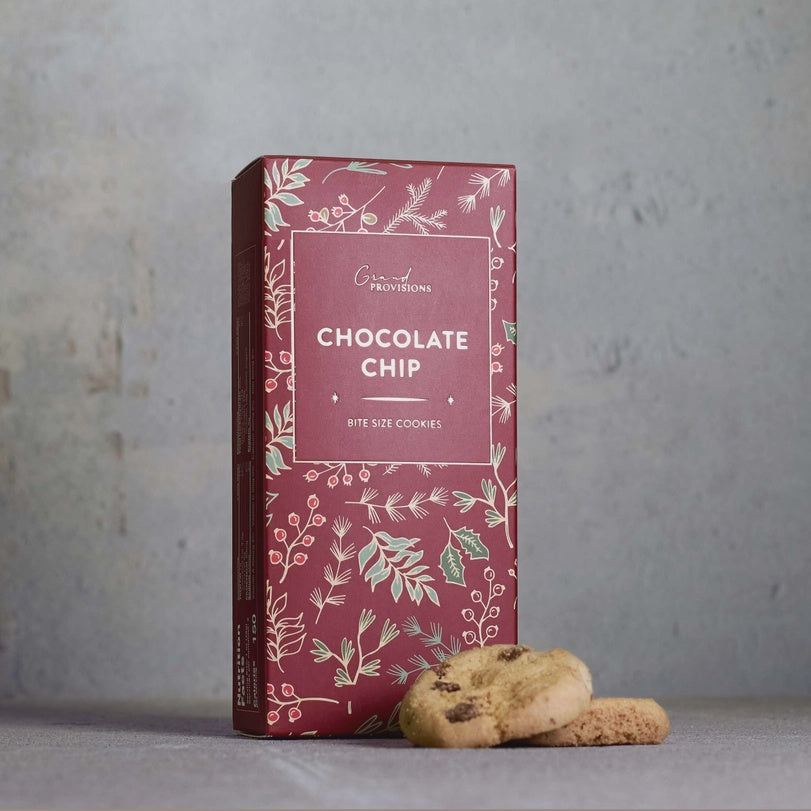 Burgundy Grand Provisions Chocolate Chip bite size cookies box with holly print and cookies beside it