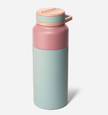Product photograph by Frank Green of a reusable insulated water bottle on a white background featuring a matte color-blocked design with a mint green body, a dusty rose shoulder, and a peach-colored push-button lid with an integrated carrying loop