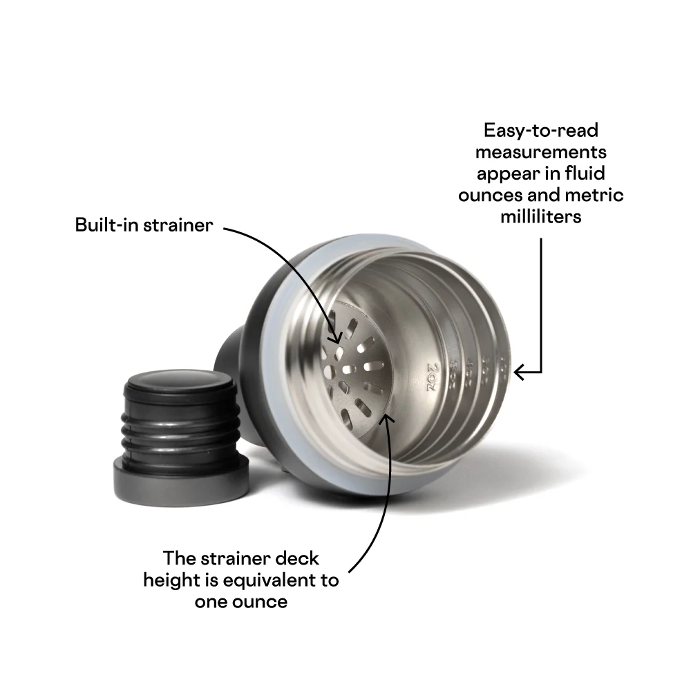 Commercial product photograph of a stainless steel cocktail shaker lid highlighting its built-in perforated strainer, one-ounce strainer deck, and engraved interior measurement markings alongside a black cap on a white background