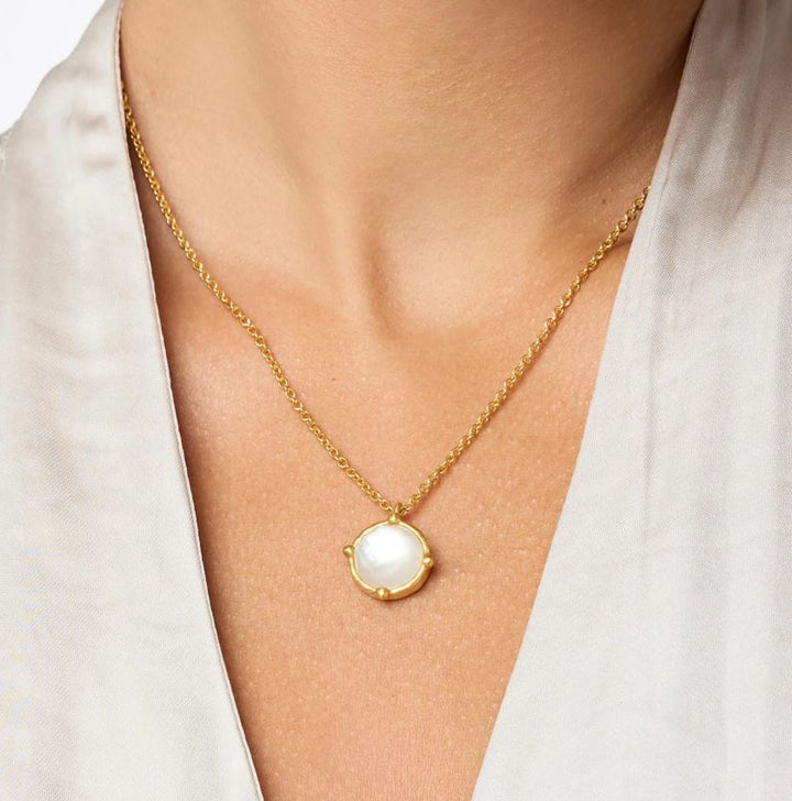 Photograph of a Julie Vos gold necklace worn on a woman&