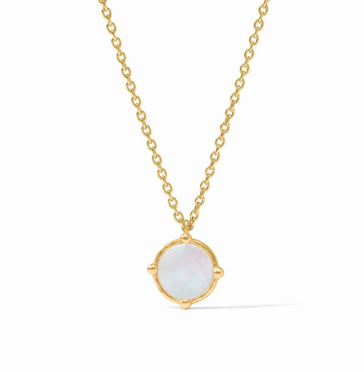Gold-tone jewelry necklace featuring a circular mother-of-pearl pendant centered on a white background with a shimmering iridescent surface, four gold bead accents at the compass points, and a delicate cable chain