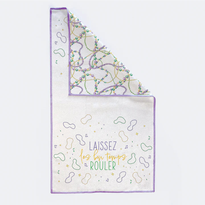 "Laissez les bon temps rouler" kitchen towel with corner folded to show Mardi Gras bead print reverse