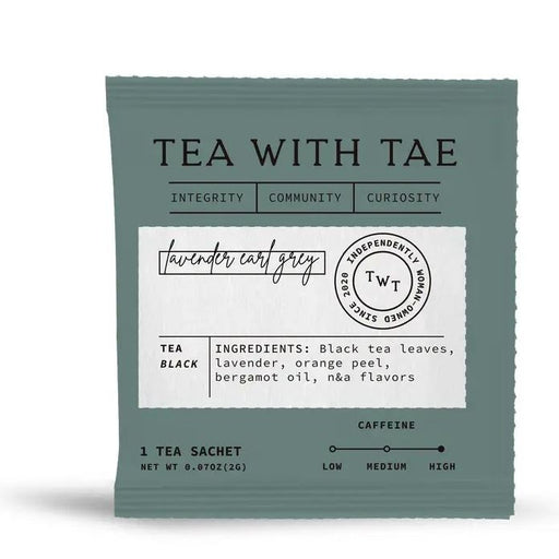 Graphic design by Tea With Tae of a muted teal Lavender Earl Grey tea sachet on a white background featuring cursive typography, a circular independently woman-owned seal, and a high caffeine level scale