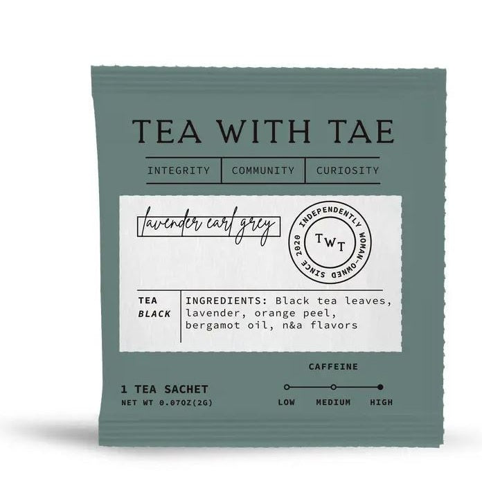 Graphic design by Tea With Tae of a muted teal Lavender Earl Grey tea sachet on a white background featuring cursive typography, a circular independently woman-owned seal, and a high caffeine level scale