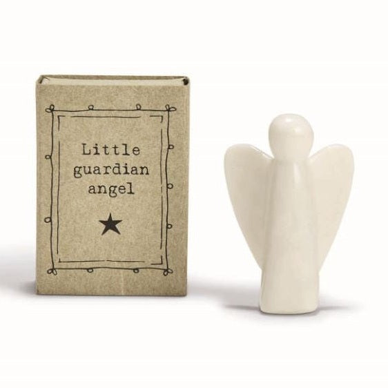 Porcelain figurine by East of India featuring a minimalist glossy white angel standing beside a rustic kraft paper box displaying the text Little guardian angel and a black star within a hand-drawn decorative border
