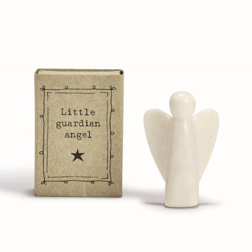 Porcelain figurine by East of India featuring a minimalist glossy white angel standing beside a rustic kraft paper box displaying the text Little guardian angel and a black star within a hand-drawn decorative border