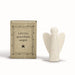 Porcelain figurine by East of India featuring a minimalist glossy white angel standing beside a rustic kraft paper box displaying the text Little guardian angel and a black star within a hand-drawn decorative border