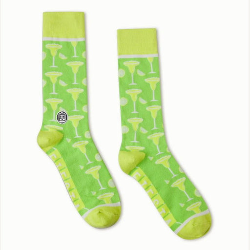 Knitted crew socks by ED Ellen DeGeneres featuring a pair of lime green socks with a repeating pattern of yellow margarita glasses and lime wedges, accented by bright yellow-green heels and toes on a white background