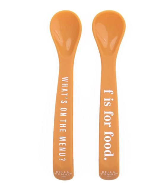 Silicone baby spoons by Bella Tunno featuring two vibrant orange feeding utensils on a white background with white typographic lettering reading WHAT&