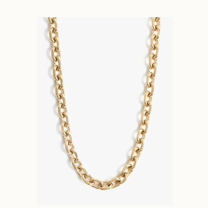 Polished gold jewelry featuring a chunky link chain necklace on a white background highlighting interlocking elongated oval links with a high-shine reflective finish and warm metallic tones