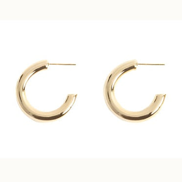 Gold jewelry featuring a pair of chunky hoop earrings on a plain white background with a high-shine polished finish, a bold tubular C-shape design, and thin straight post backings