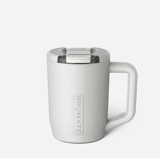 Product photography by BrüMate of a matte white insulated travel mug in a studio setting featuring a vertical embossed logo, a clear splash-proof lid with a sliding latch, and an ergonomic handle
