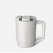 Product photography by BrüMate of a matte white insulated travel mug in a studio setting featuring a vertical embossed logo, a clear splash-proof lid with a sliding latch, and an ergonomic handle