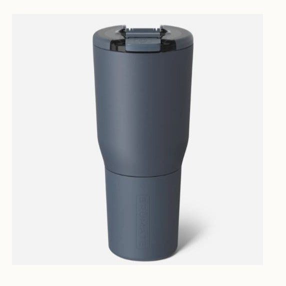 Product photograph of a BrüMate insulated travel tumbler in matte navy blue on a white background featuring a locking spill-proof lid and a tapered base with a debossed brand logo