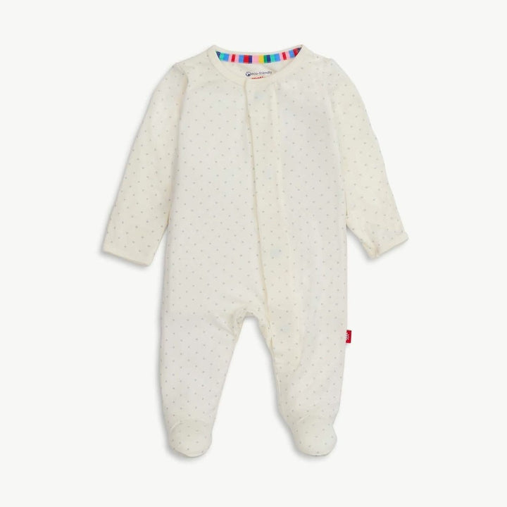 Product photograph of a Mori brand baby onesie featuring an off-white footed sleepsuit with a subtle grey star pattern, a vibrant rainbow-striped inner neckline, and a signature red logo tag on the side seam