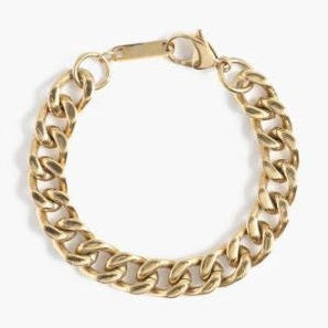 Gold-colored metal jewelry chunky curb chain bracelet centered on a plain white background featuring a polished gold finish, a secure lobster claw clasp, and a small rectangular metal tag link