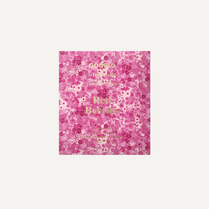 Packaging design by Goodio featuring a Red Berries craft chocolate bar centered on an ivory background with an intricate pink floral pattern and shimmering gold foil typography