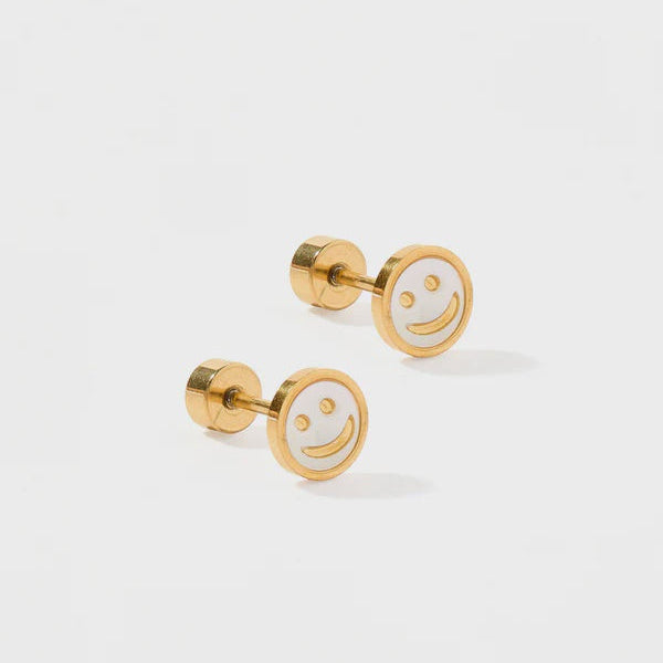 Gold-toned metal and white enamel stud earrings showcasing an iconic smiley face design on a light gray surface with glossy white centers and secure screw-on flat backings