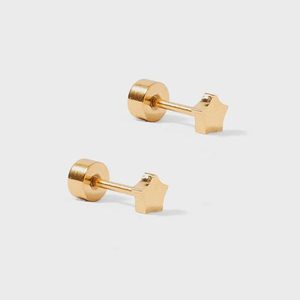 Gold-tone metal jewelry featuring a pair of star-shaped stud earrings on a light gray background with cylindrical flat-back screw posts and a polished metallic five-point star silhouette