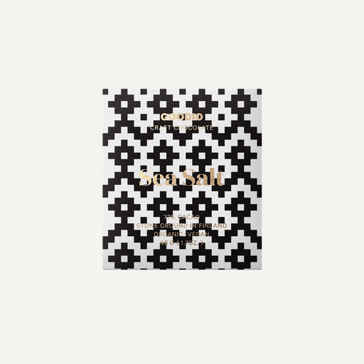 Graphic design packaging by Goodio features a Sea Salt chocolate bar from Finland highlighting a bold black and white pixelated geometric pattern, elegant gold foil typography, and a minimalist white background