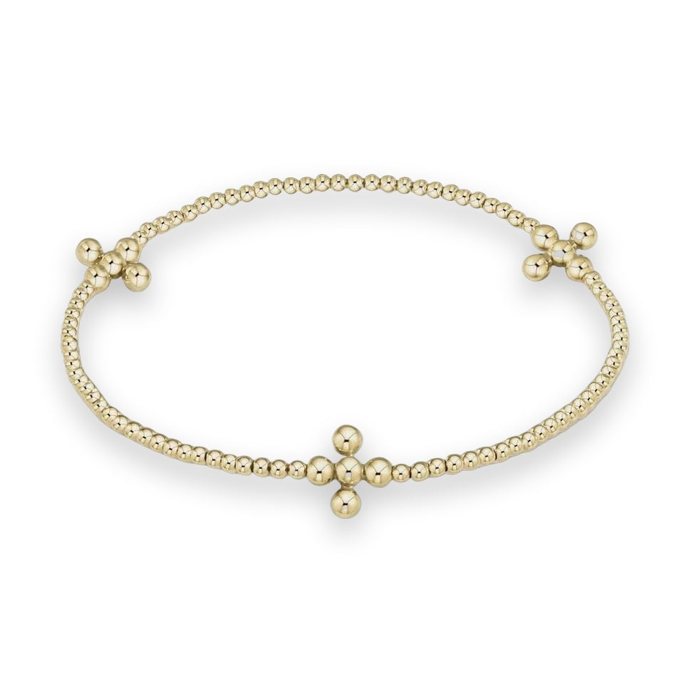 Yellow gold Perlée clovers bracelet by Van Cleef &amp; Arpels featuring a sequence of polished spheres and three symmetrical clover-shaped motifs on a minimalist cream background