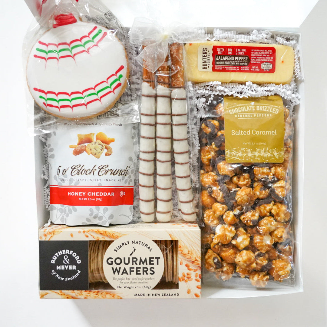 Assorted snack items including cookies, crackers, and popcorn on a white background