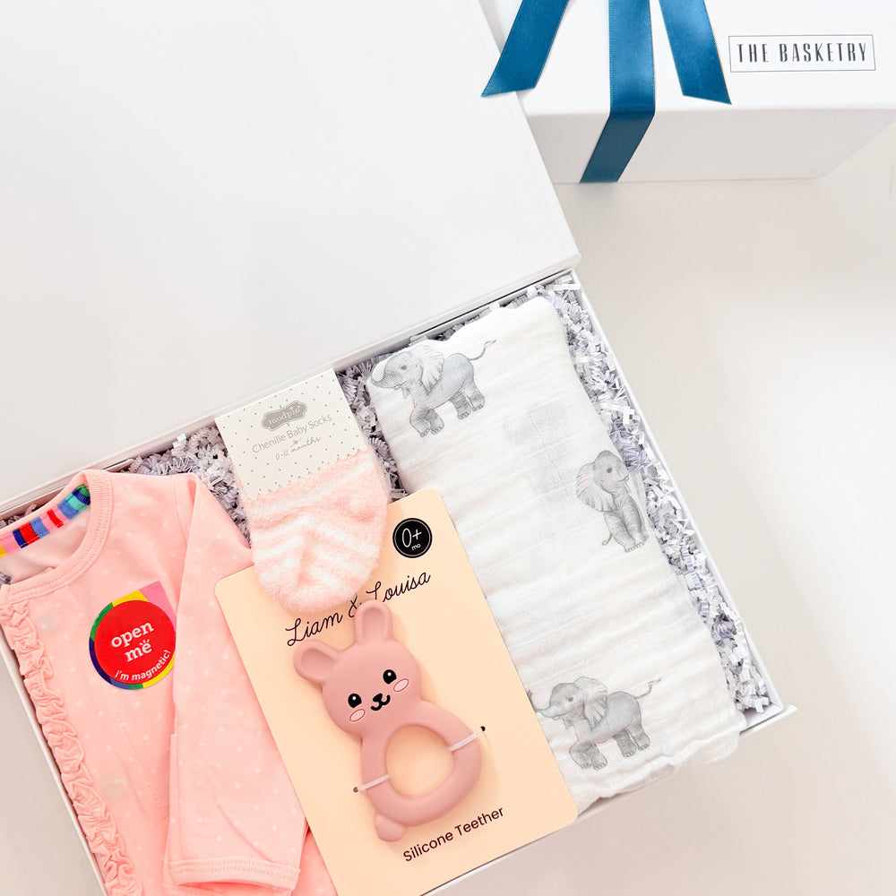 Set of three face masks in pink, yellow, and gray with a blue ribbon on a white background