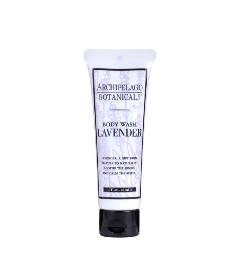 Studio product photograph by Archipelago Botanicals of a travel-sized lavender body wash tube centered on a white background, highlighting its purple botanical drawings, bold black branding, and a sleek black cap