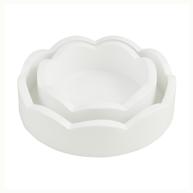 Sculpted white resin nesting bowls featuring a scalloped flower petal silhouette centered on a plain background with a smooth matte finish and tiered minimalist design