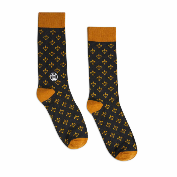 Fabric socks by Bonfolk featuring a New Orleans inspired design with a repeating golden fleur-de-lis pattern on a black base, a white streetcar logo, and vibrant mustard yellow cuffs, heels, and toes