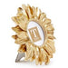 Decorative gold-toned metal frame by Tess Taylor Collection featuring a sunflower-shaped subject on a white background with layered metallic petals, a circular photo aperture, and a gray easel stand