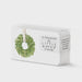 Watercolor illustration by E. Frances Paper of 85 Little Notes stationery cards in a clear box featuring a lush green leafy wreath with a white ribbon and crisp black typography