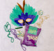 Mardi Gras snacks with feather mask and Mardi Gras beads festive gift box