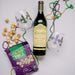 Fancy Mardi Gras gift with Caymus wine, MIgnon Faget wine glasses, Mardi Gras Beads, and king cake popcorn.