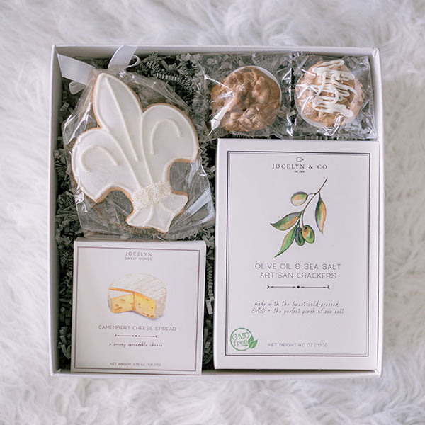 Cheese and crackers paired with cookies and pralines gift box hostess gift