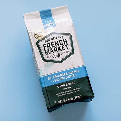 French Market Coffee bag, St. Charles Blend dark roast ground coffee, on a blue background