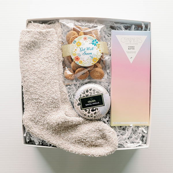 Cozy socks, snacks and a candle gift box