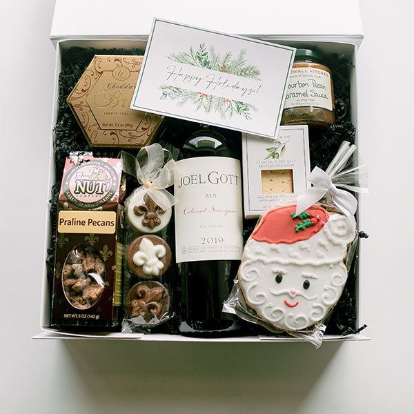 Christmas wine box filled with sweet and savory snacks.
