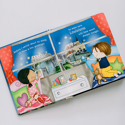 Night Night Louisiana book open to an illustrated bedroom scene with two children at a window