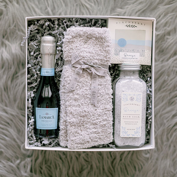Finchberry bath salts and soap, Barefoot Dreams socks, LaMarca Prosecco relaxation gift box