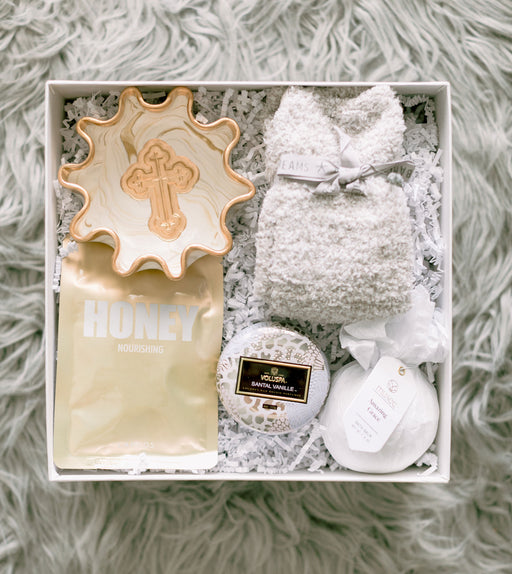 Barefoot Dreams socks, face mask, Voluspa candle, and Musee bath bombs.