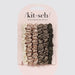 Satin scrunchies by Kitsch featuring a six-piece set of hair accessories in a neutral gradient from ivory to olive green with a lustrous ruched texture on a light pink display card